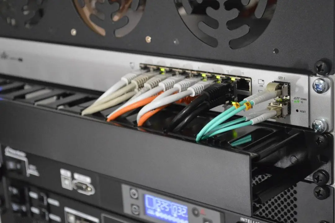 Close-up of network switch in a server rack with ethernet and fibre optic cables connected